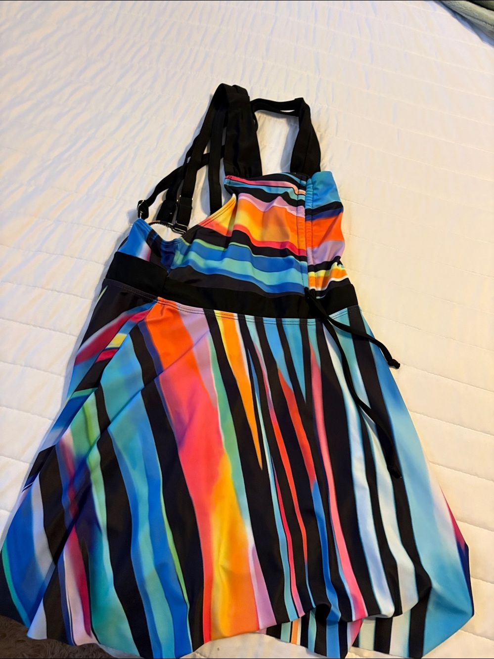 Vibrant women's rainbow striped tankini top designed for swimming